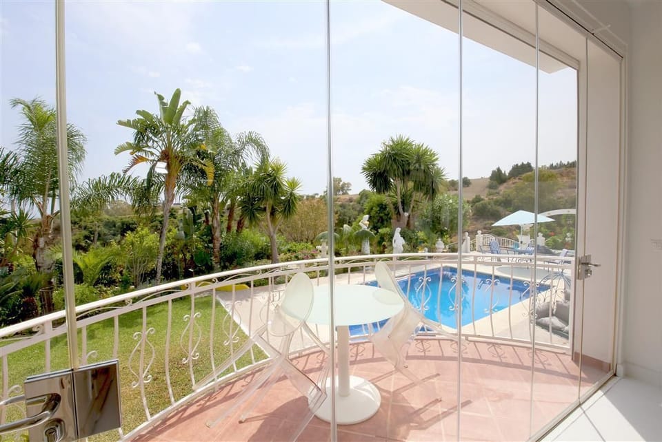 Beautiful views to the gardens and pool from the living room