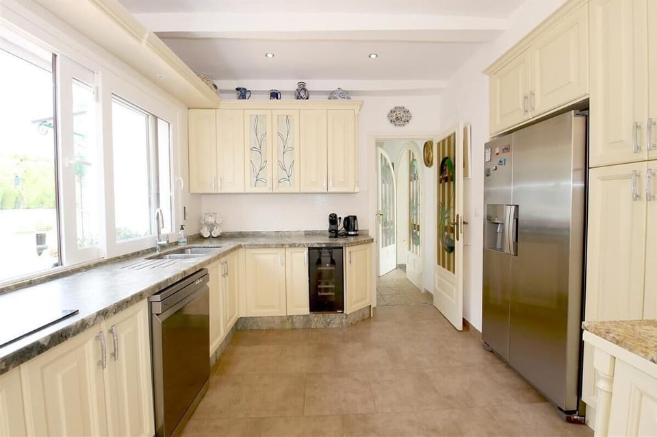 Large and bright kitchen is fully equipped with all the appliances