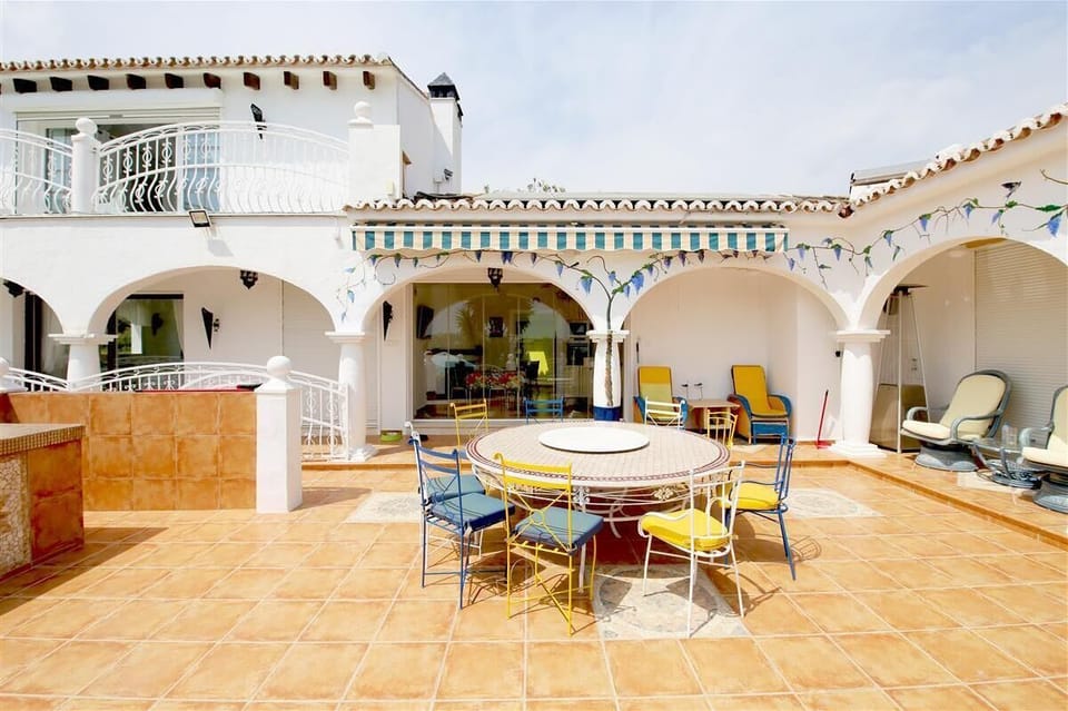 Large and sunny terrace with outdoor dining area and sunbeds