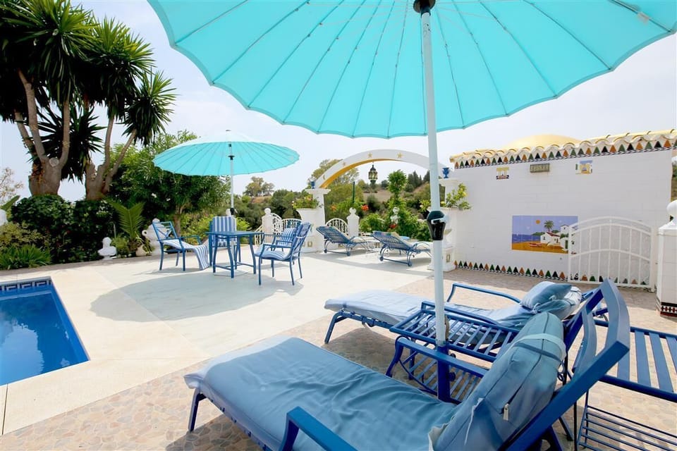 Lots of sunbeds and outdoor chairs next to the pool area