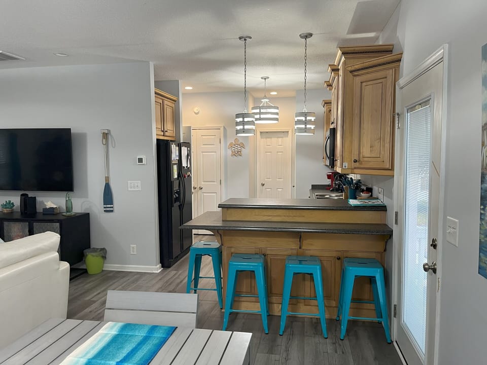 Bar seating and view of kitchen