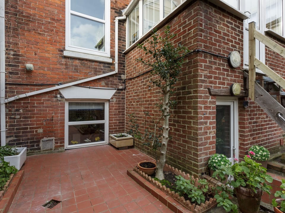 Garden area shared with neighbours, secure for children.