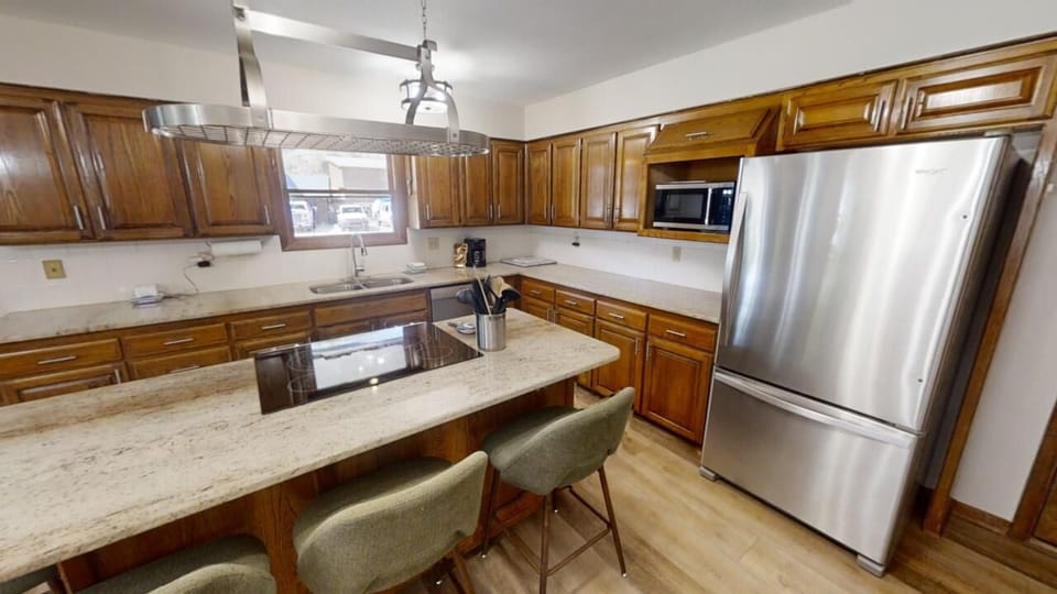 Your fully equipped kitchen features granite countertops, stainless steel appliances, and a spacious island perfect for preparing meals or gathering with loved ones.