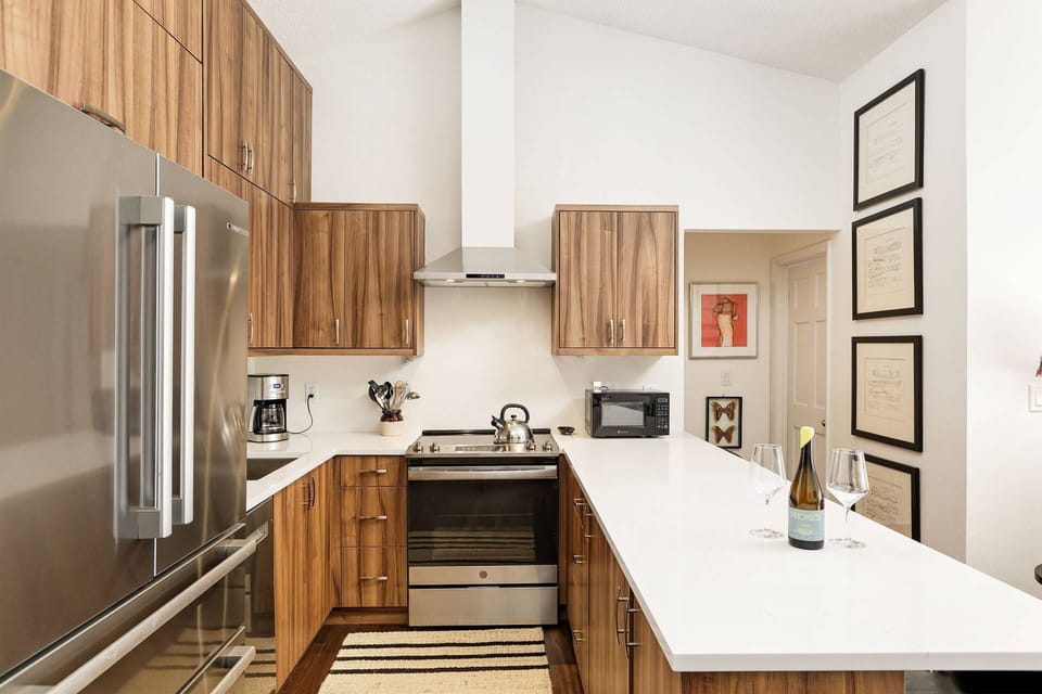 Beautiful new cabinets make this well stocked kitchen a joy to cook in.