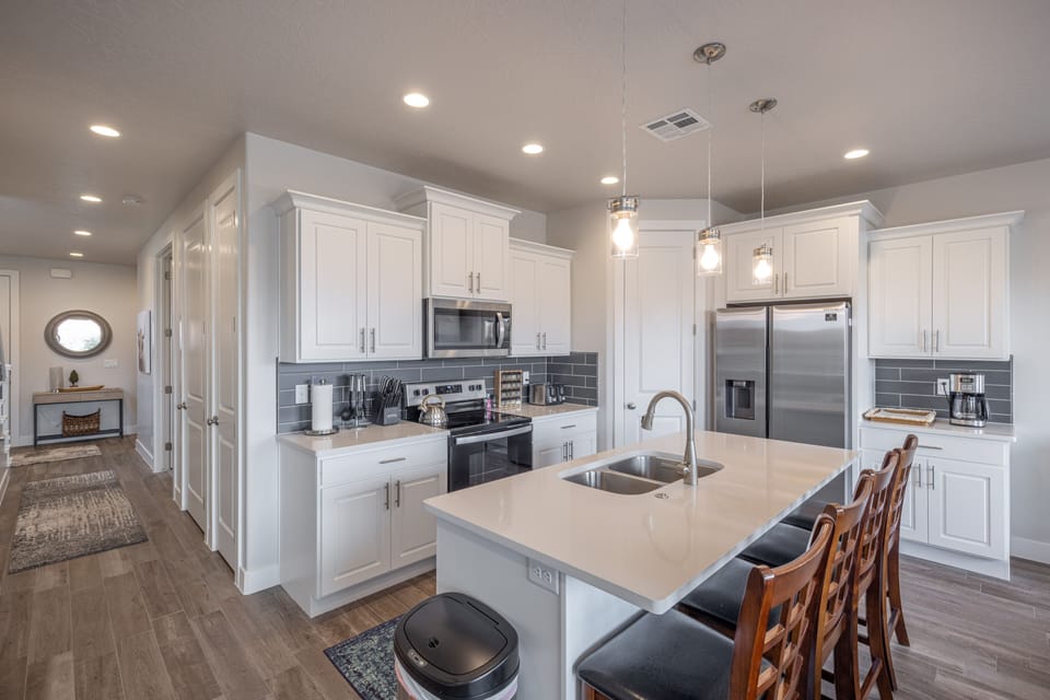 Kitchen Island View of Kitchen - The Kitchen is complete with everything you will need for meal preparations including pots, pans, baking dishes, plates, cups, silverware, cutlery, and an assortment of cooking utensils.