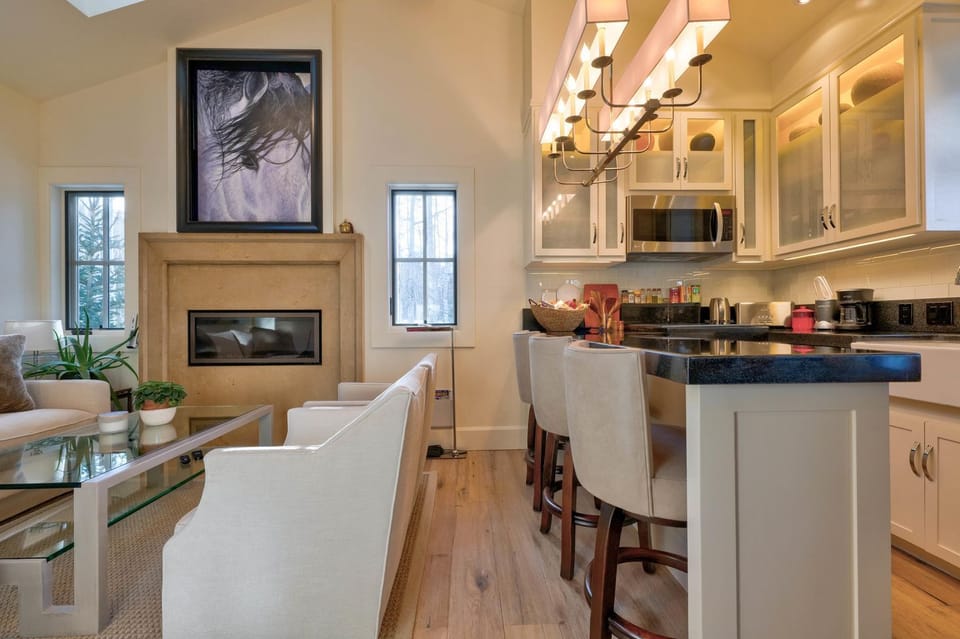 View into living and kitchen area (TV above fireplace)