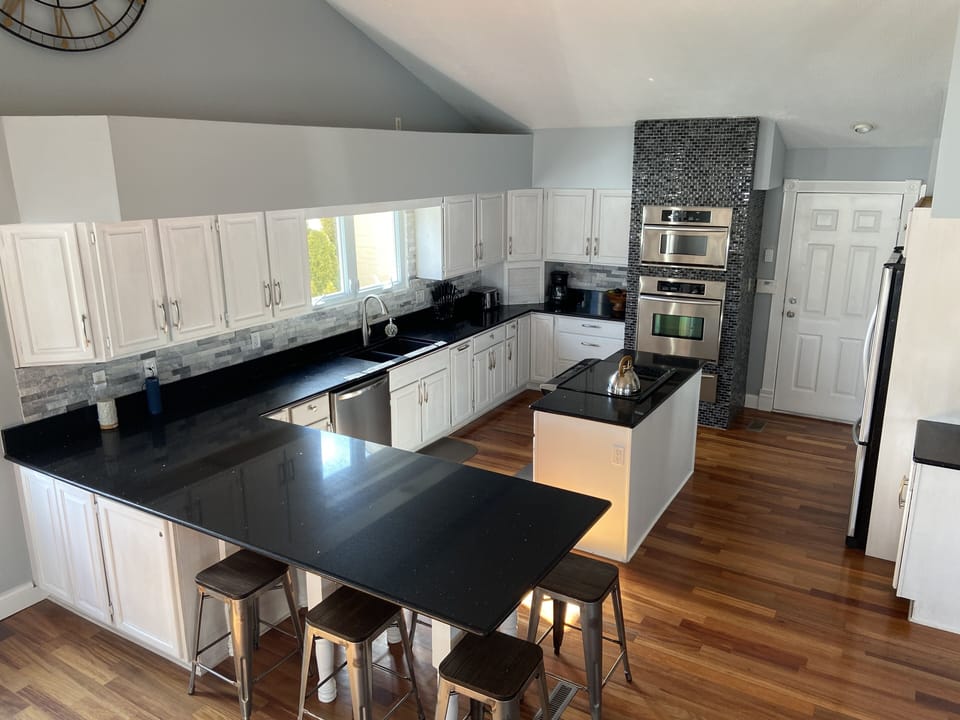 Kitchen, dishwasher, fridge, microwave, and dual ovens.