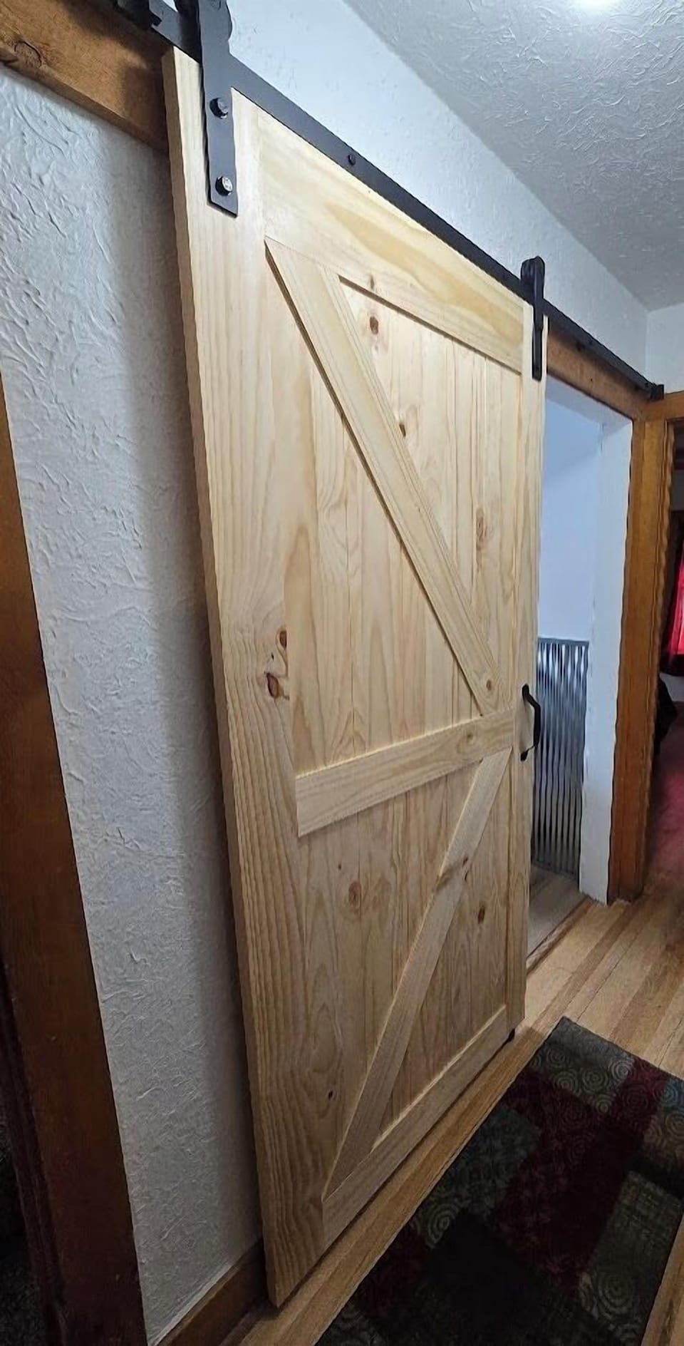 Barn style sliding door to Bathroom 1 on the main level