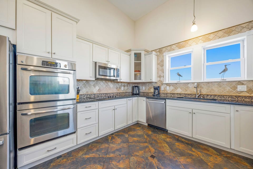 Your gourmet kitchen awaits with stainless steel appliances, elegant tile backsplash, and ample counter space for creating memorable meals.