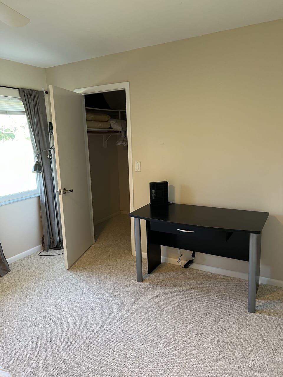 Guest room with desk and walk-in closet