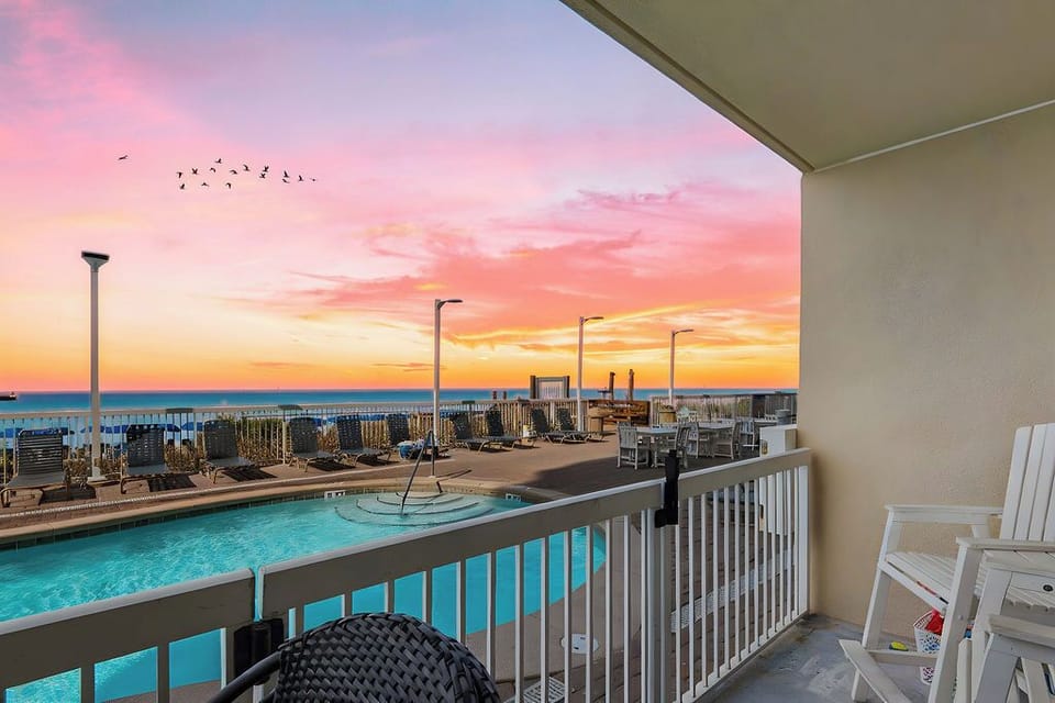 Sunset views from your balcony overlooking pool and beach