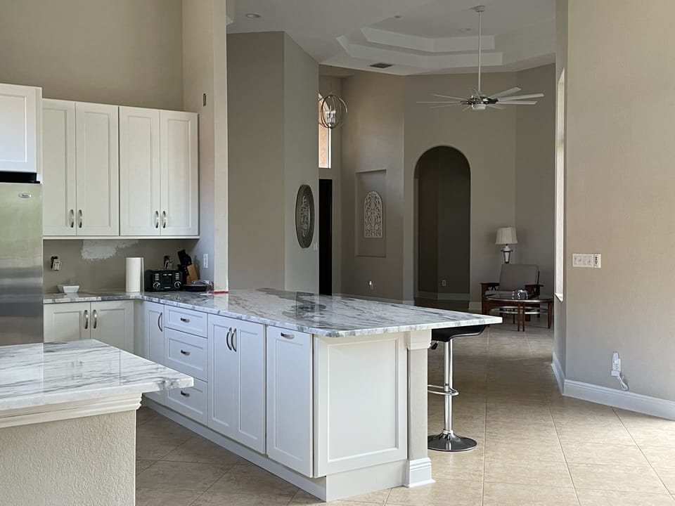 Kitchen with counter seating.  Open to entry sitting area and gathering room. 