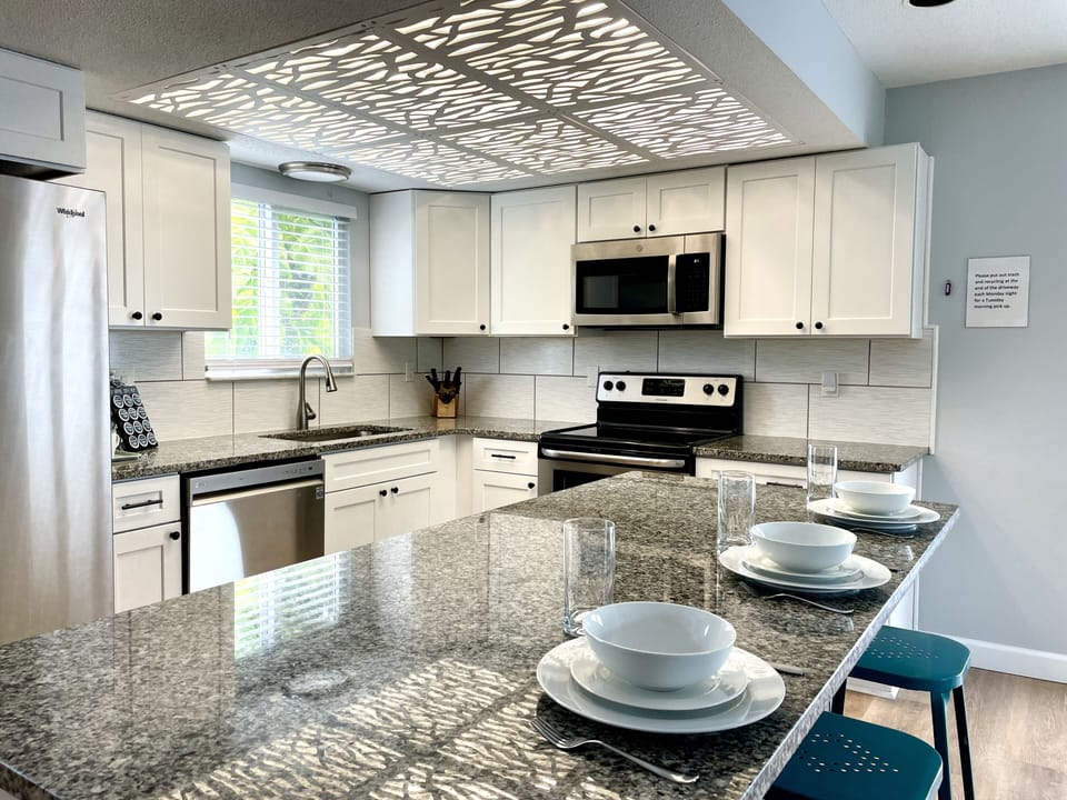 Newly remodeled, well stocked kitchen has all the room and wares you need.