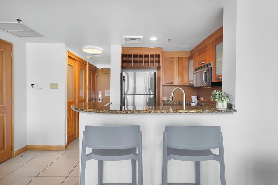 The kitchen has 2 stools to enjoy your meals.