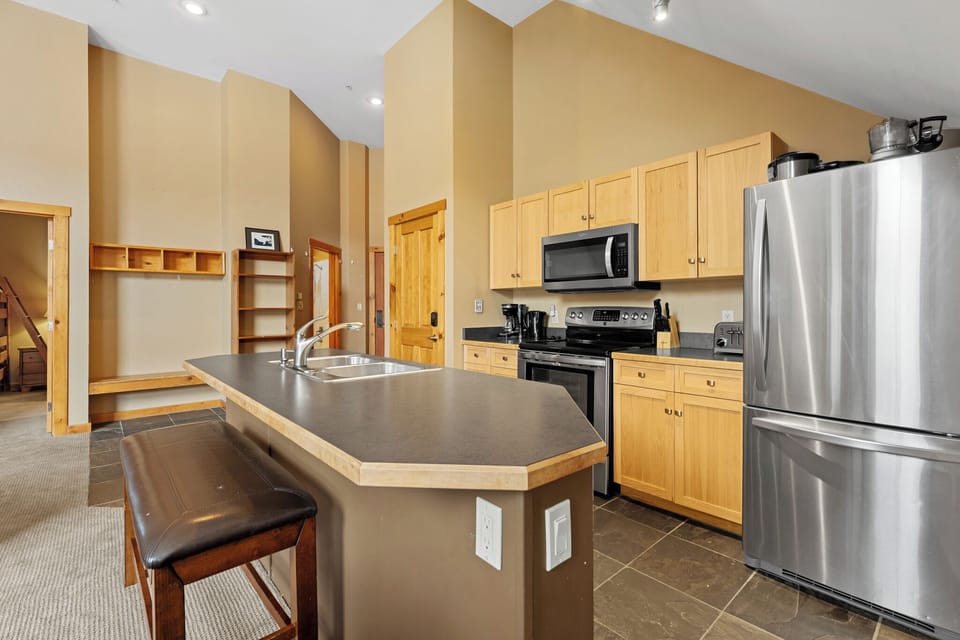 Full kitchen with stainless steel appliances.