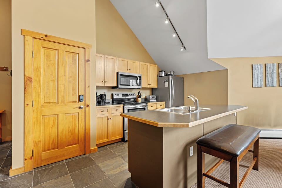 Full kitchen with stainless steel appliances.