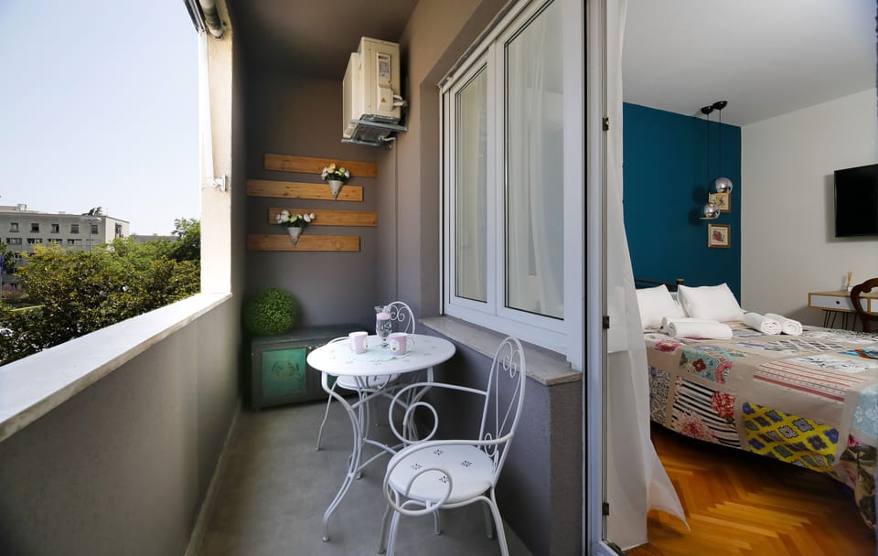View from balcony with outdoor sitting area.