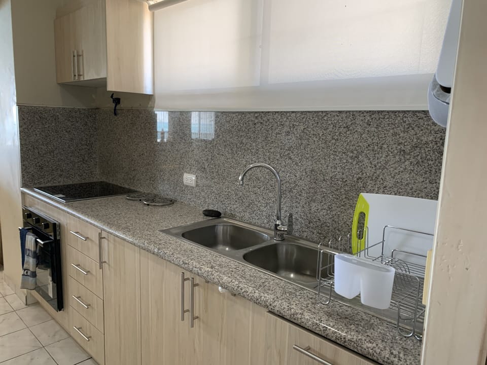 Full kitchen with main appliances & dinnerware.