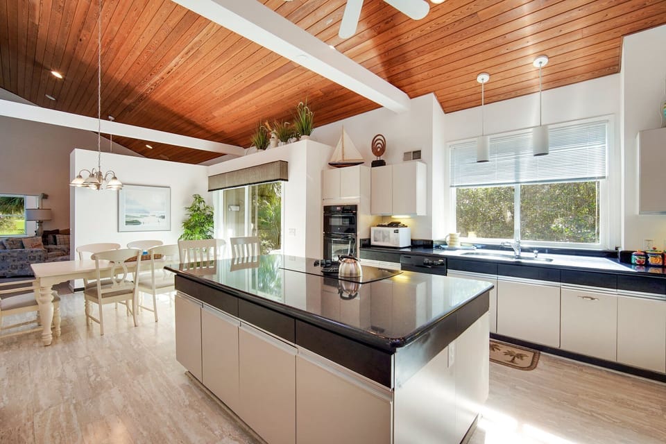 Fully equipped kitchen with stainless steel appliances and large island. 