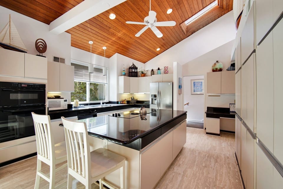Fully equipped kitchen with stainless steel appliances and large island. 