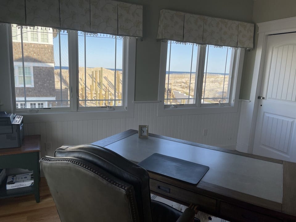 Office within desk, chair, and ocean views. Great for work from home. 