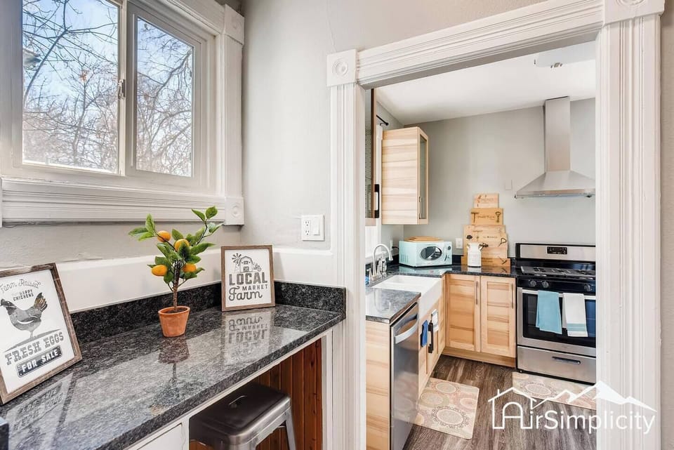 - Charming breakfast nook with granite counter, stool, and a citrus plant for color
- Leads directly into the main kitchen with sleek appliances and a farmhouse sink
- Great spot for morning coffee or a snack break between activities
