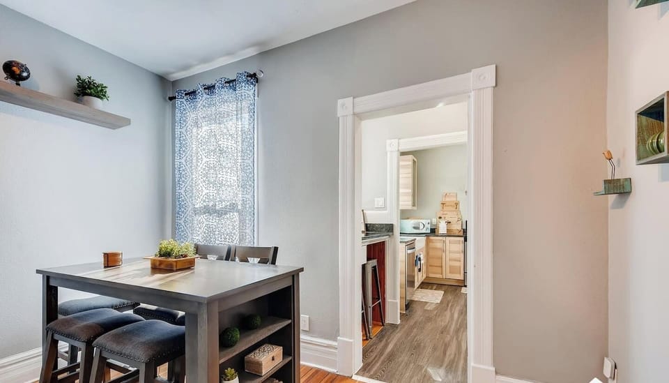 - Compact dining space with a tall table and storage shelves, perfect for quick bites or work
- Natural light streams in from the window, giving the nook a fresh and airy vibe
- Direct access to the kitchen makes mealtime easy and social

