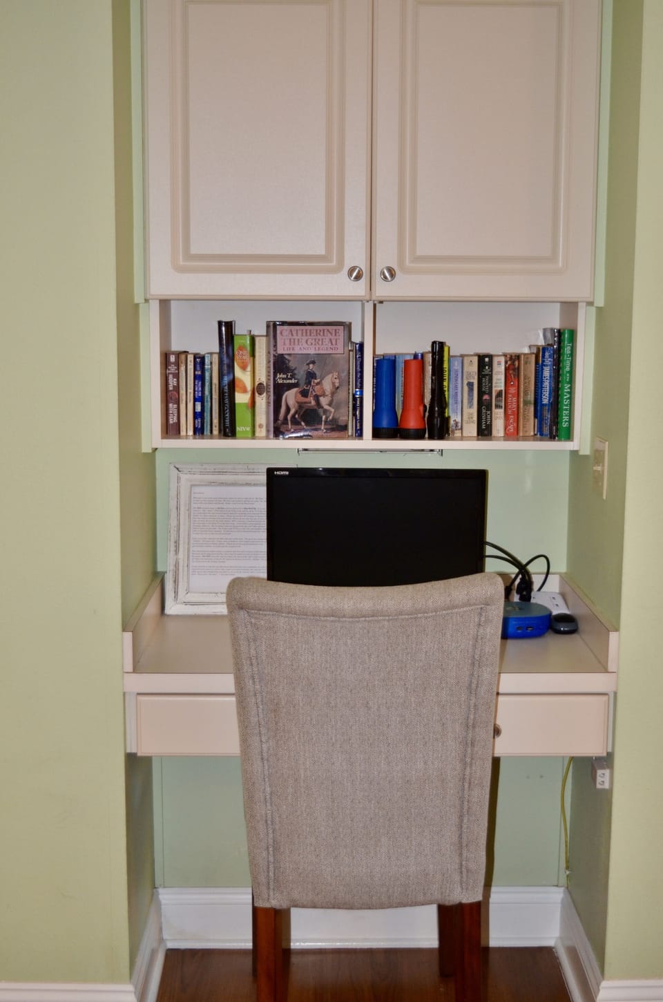 Desk with small desktop provided for guest use.