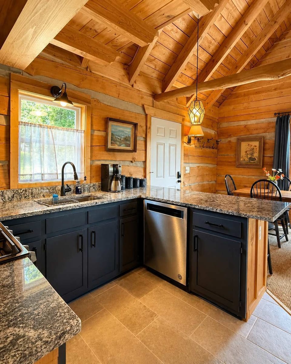 Open Concept Kitchen with Granite counters, stainless appliances, gas stove, custom hood, dishwasher, ceramic tile floors, and peninsula with 2 stools.