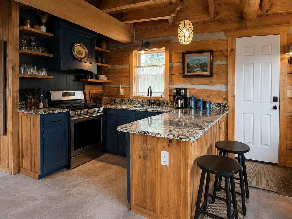 Open Concept Kitchen with Granite counters, stainless appliances, gas stove, custom hood, dishwasher, ceramic tile floors, and peninsula with 2 stools.