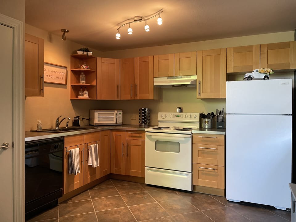 The kitchen has a stove, oven, dishwasher and refrigerator.