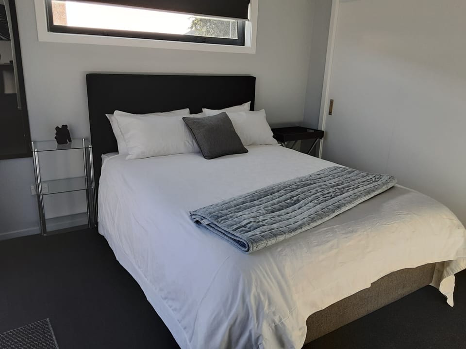 queen size bed, in a cost bright room. Has a slighting door to the porch