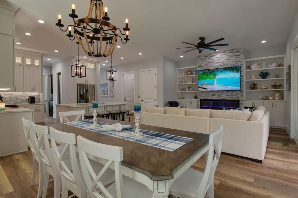 Open floor plan with 10ft. ceiling, dining, living room with fireplace, 75in. TV