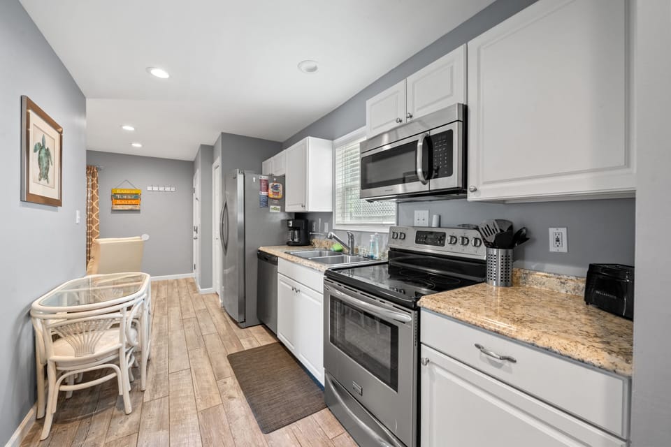 Fully equipped kitchen with stainless steel appliances.