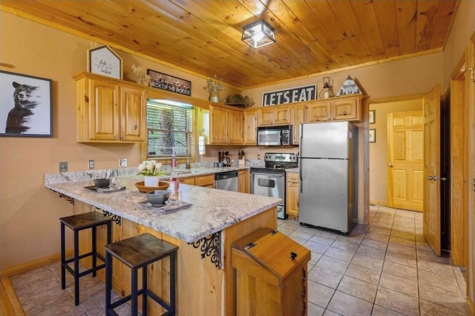 Fully stocked kitchen with upgraded countertops and stainless steel appliances.