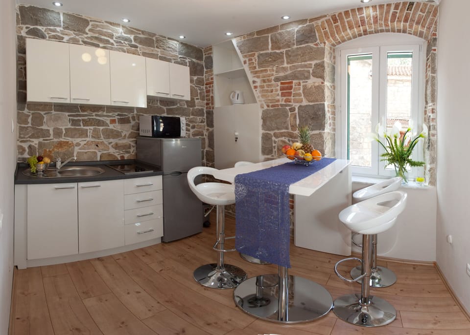 Dining area with the kitchen in the background.