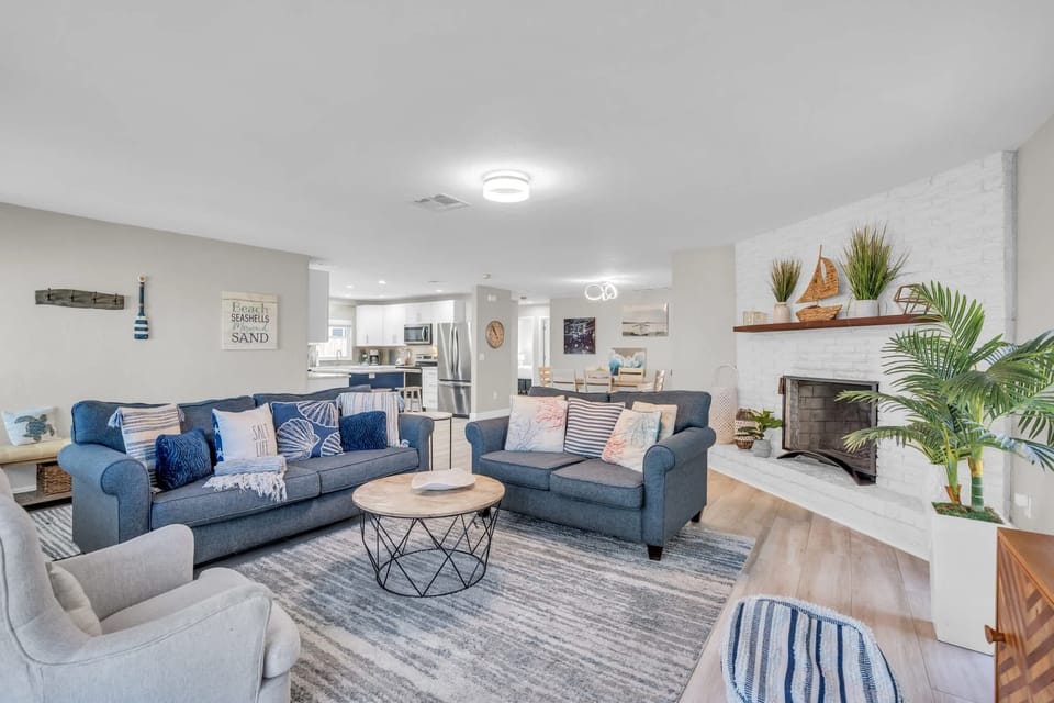 The Family Room of the Home is Warm and Inviting with Large Windows and TV