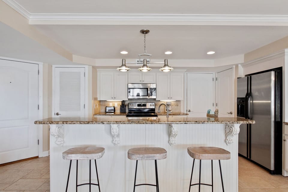 Granite counter with three stools