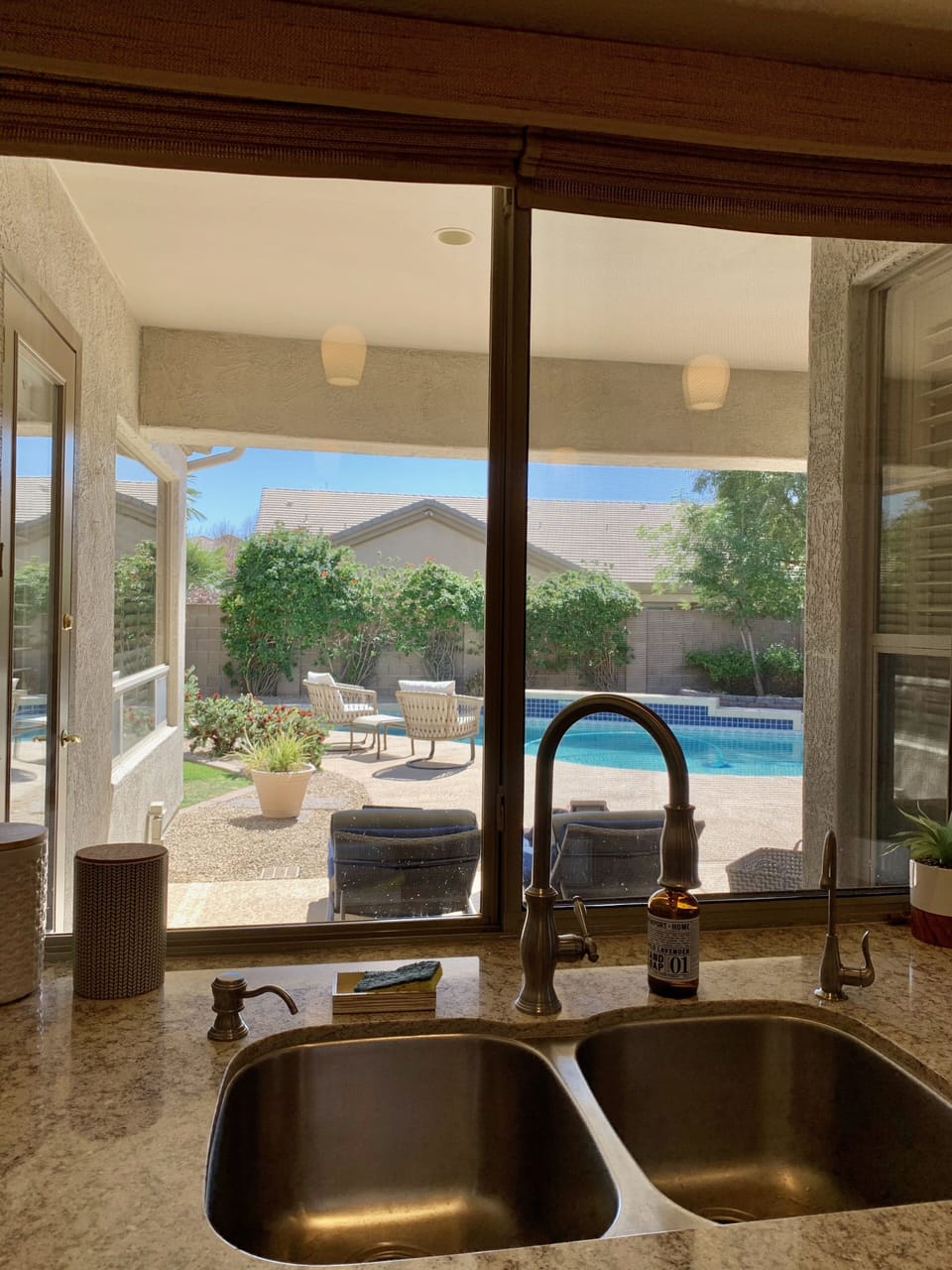 Kitchen area offers full backyard and pool view.