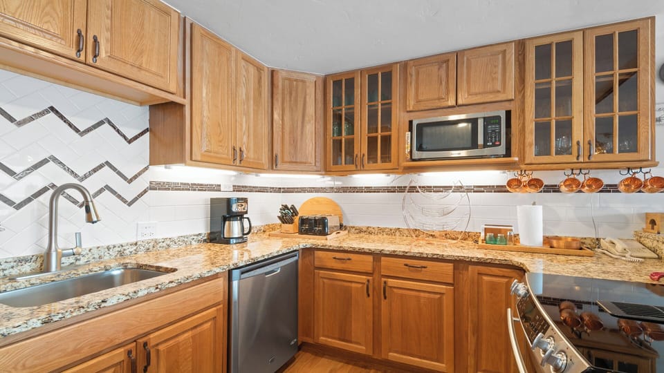 Your well-equipped kitchen awaits, complete with granite counters, stainless appliances, and ample cabinet space—perfect for preparing delicious meals together.