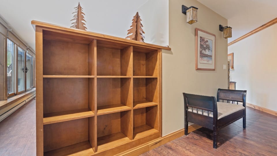 Store your gear in this charming custom wooden unit while relaxing on the nearby bench—your personal retreat after a day of adventure.