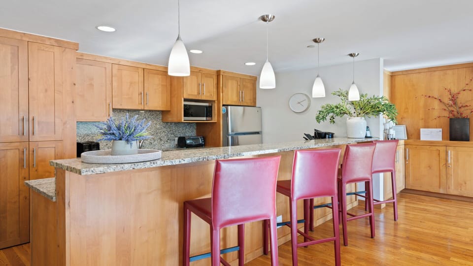 Gather around the spacious granite island, where modern appliances and warm wood tones create your home-away-from-home cooking and dining experience.
