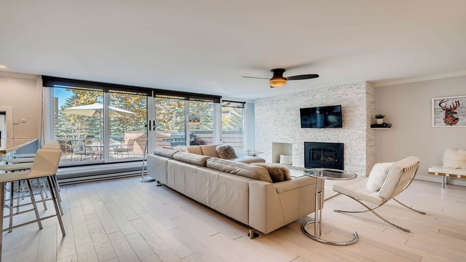 Unwind in your bright, modern living room where a cozy fireplace and natural light create the perfect retreat. Step outside to your private balcony to savor mountain views.