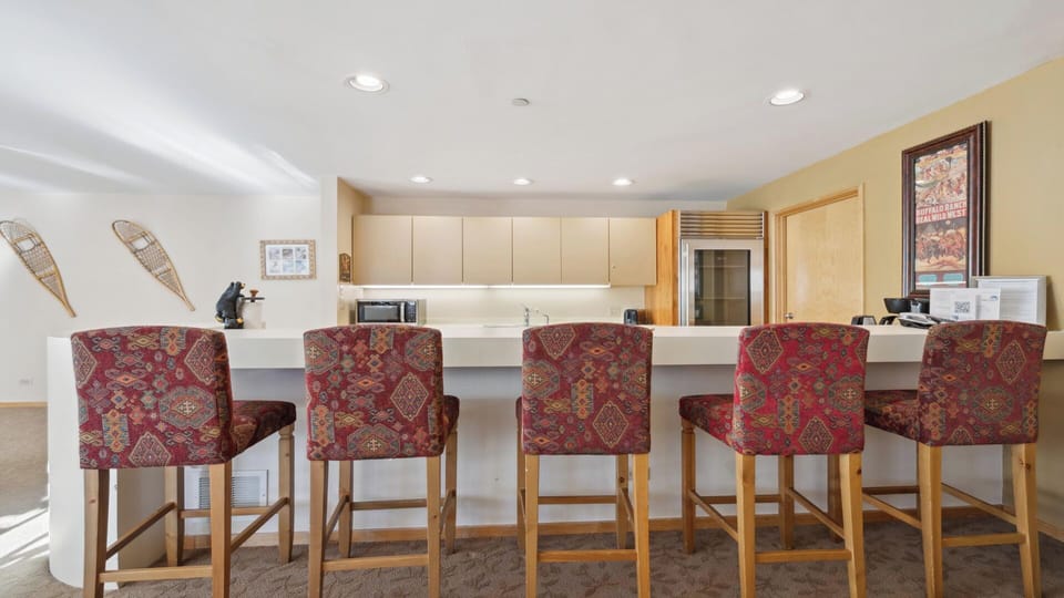 Gather around the breakfast bar for morning coffee or casual meals. Stylish upholstered stools and gleaming countertops create the perfect spot to start your day together.