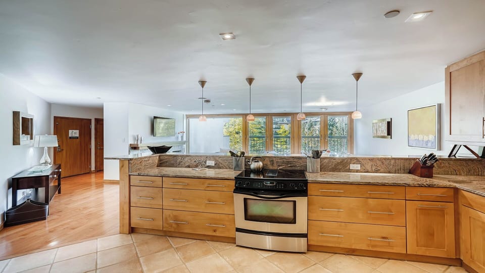 Step into your bright, fully-equipped kitchen with marble countertops, modern appliances, and natural light. Cook your favorite meals while enjoying peaceful views through the large windows—this inviting space is ready for your arrival.