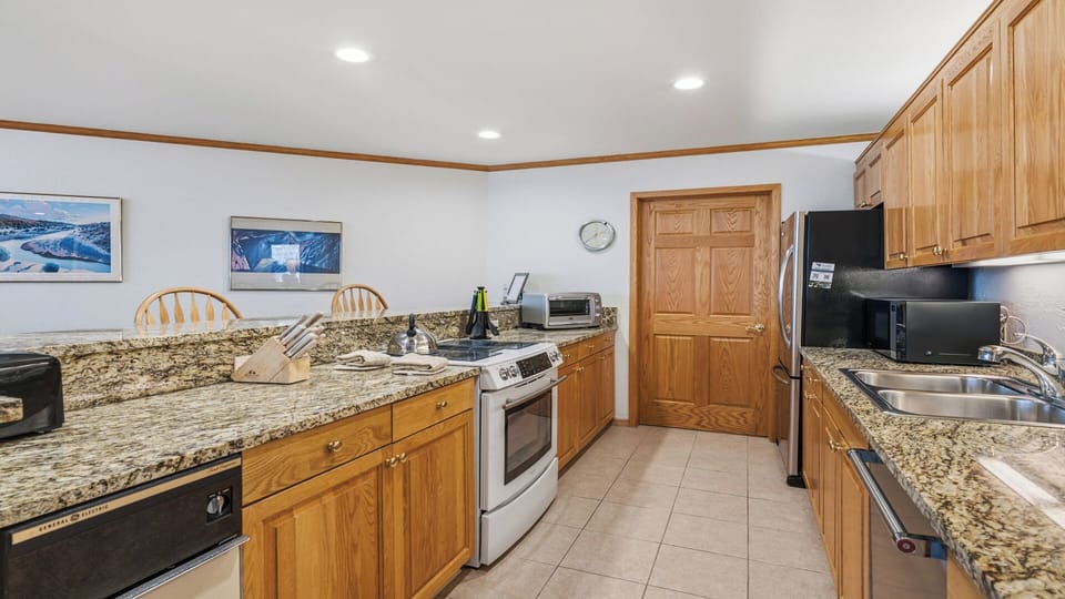 Your fully equipped kitchen features granite countertops, stainless appliances, and everything you need to prepare meals together during your mountain getaway.