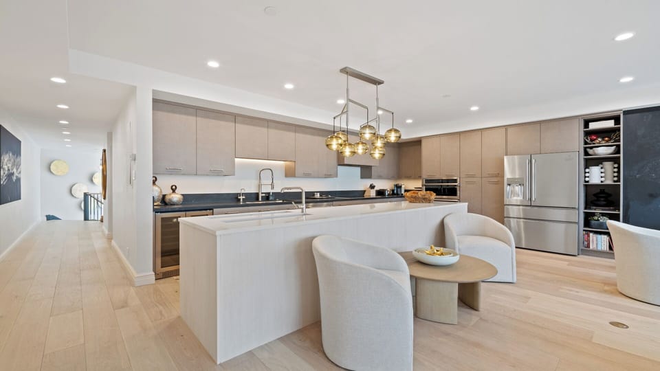 Your gourmet kitchen features sleek cabinetry, granite countertops, stainless steel appliances, and a center island perfect for casual dining or meal prep.