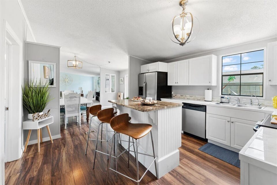Stylish open kitchen with island seating, perfect for easy meals and mingling.
