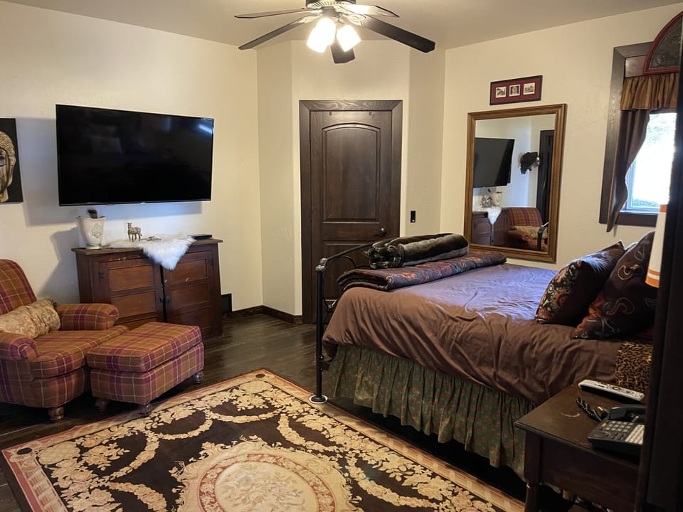 Master Suite features a King Bed, 50” Smart TV, Natural Rough Saw Wood floors