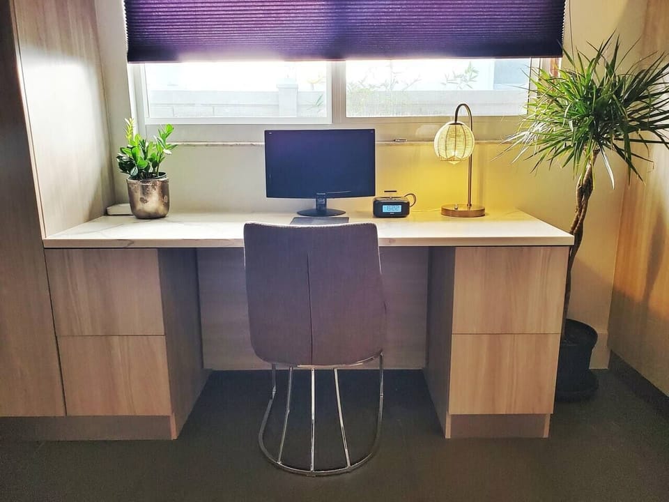Guest room office space with computer monitor and printer. 